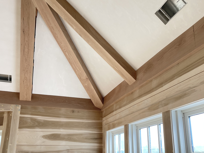Exposed wooden beam ceiling installed by finish carpenter in Cape Cod